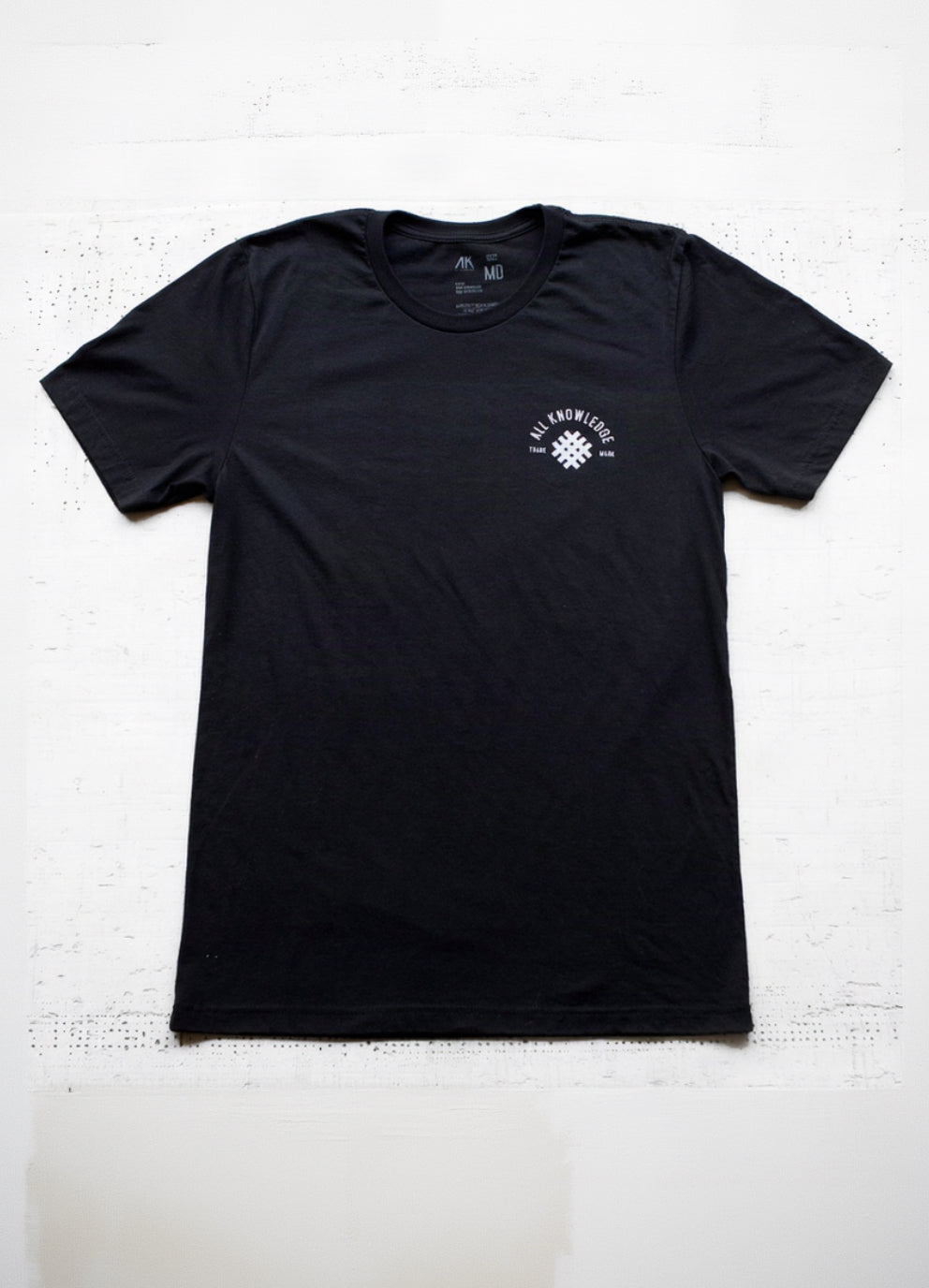 A black short-sleeve crewneck t-shirt with all knowledge mesh on the chest
