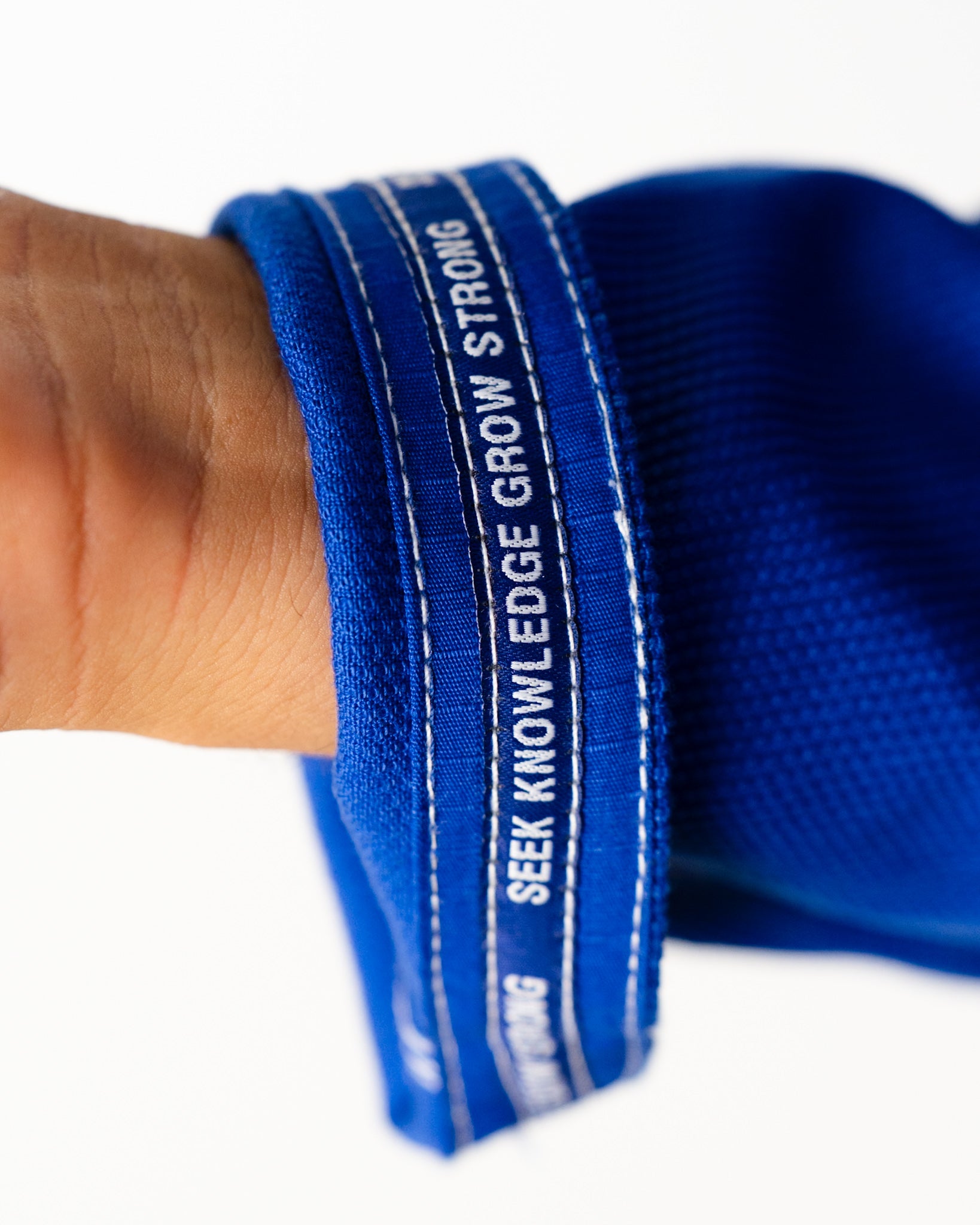 Blue Gi with meaning: Seek Knowledge Grow Strong sleeve